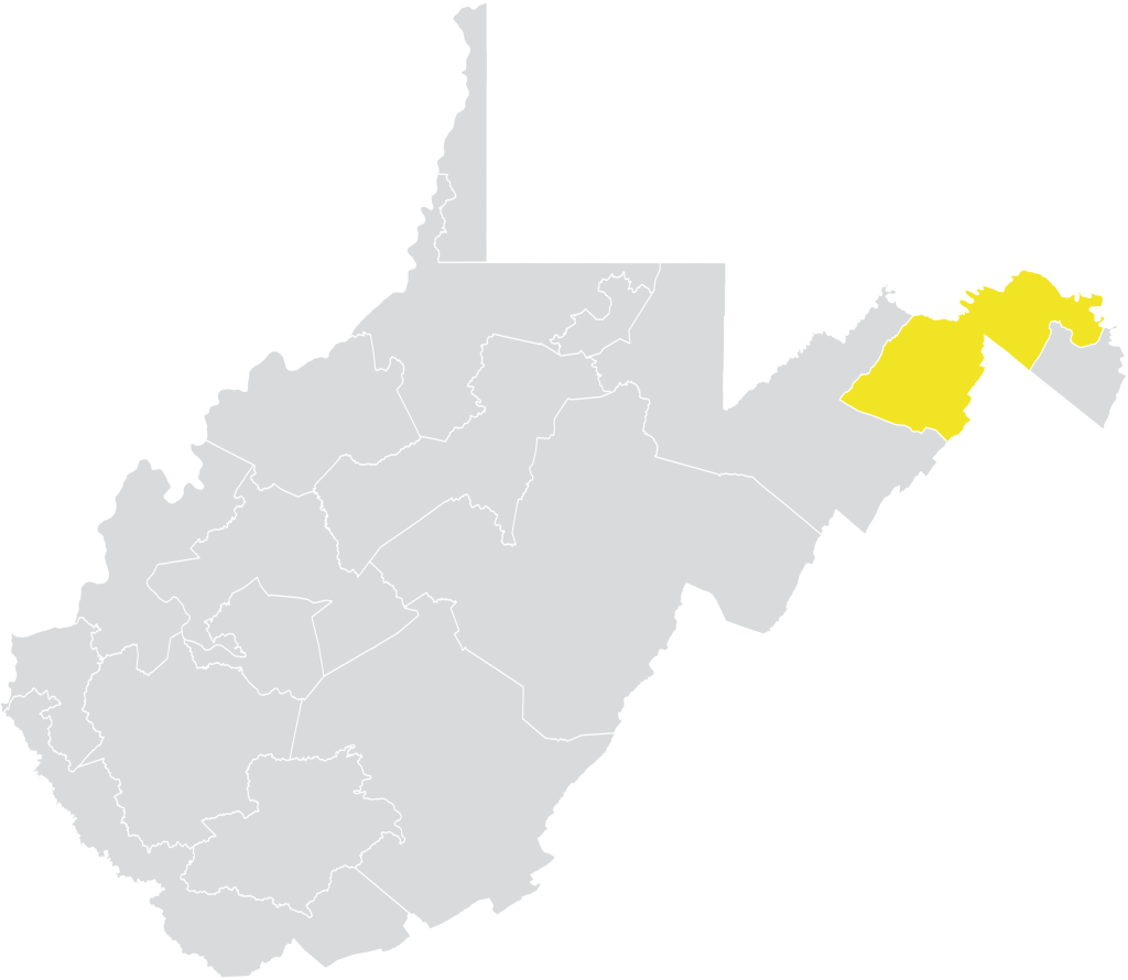 Silhouette of the state of West Virginia in grey, with a portion of the Eastern Panhandle highlighted in yellow.